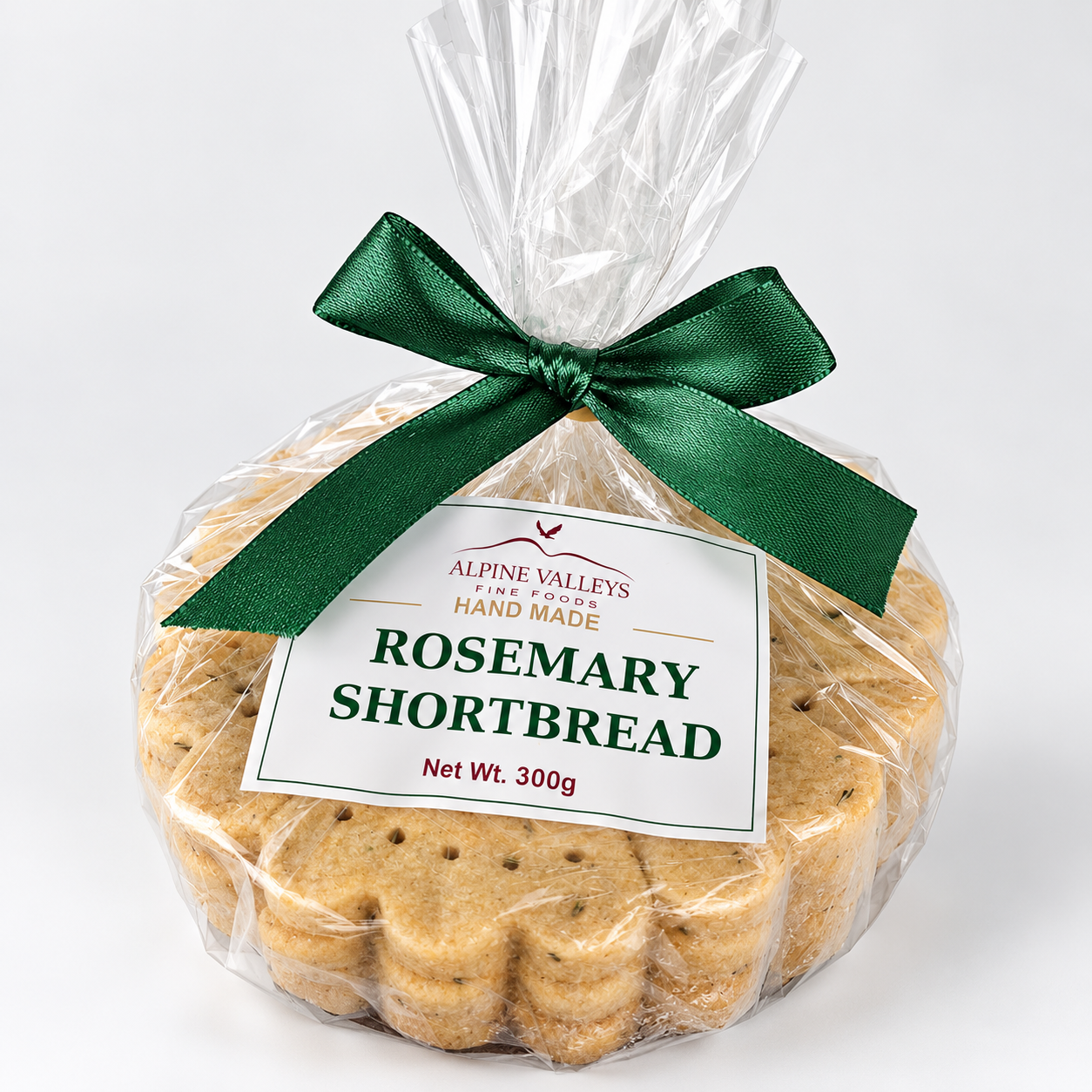 Close-up of Alpine Valleys Fine Foods Rosemary Shortbread 300g, showing handmade golden biscuits, forest green satin ribbon and branded gift packaging.